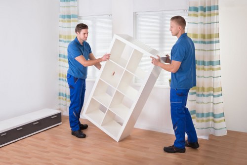 Commercial movers handling office furniture in a Lambeth building